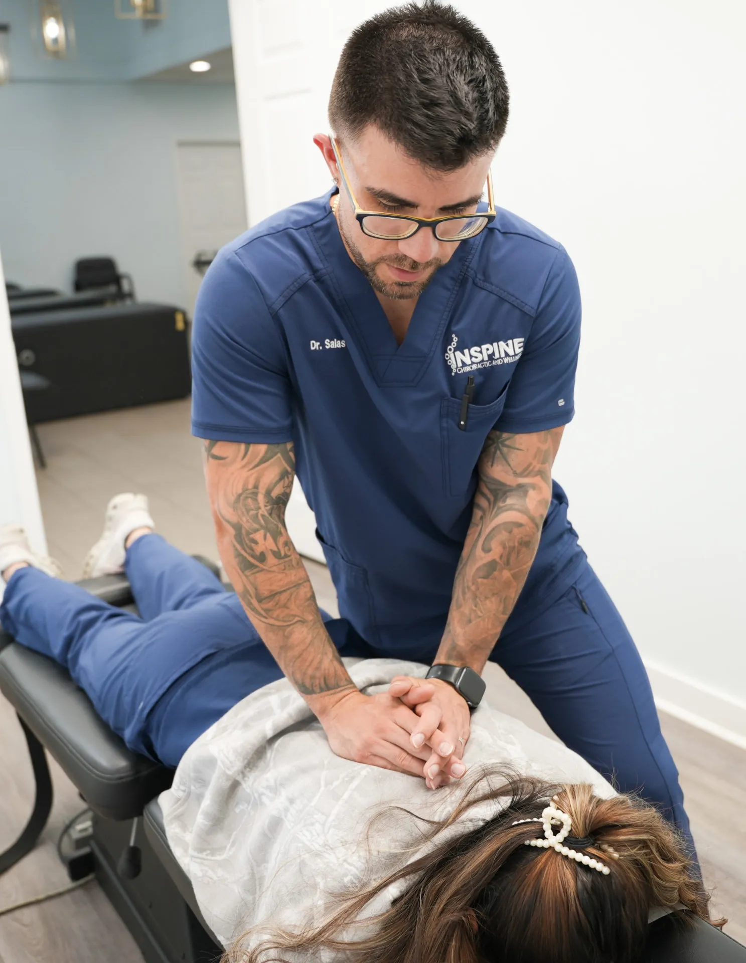 Dr. Salas performing a chiropractic adjustment on a patient's back at Inspine Chiropractic and Wellness.